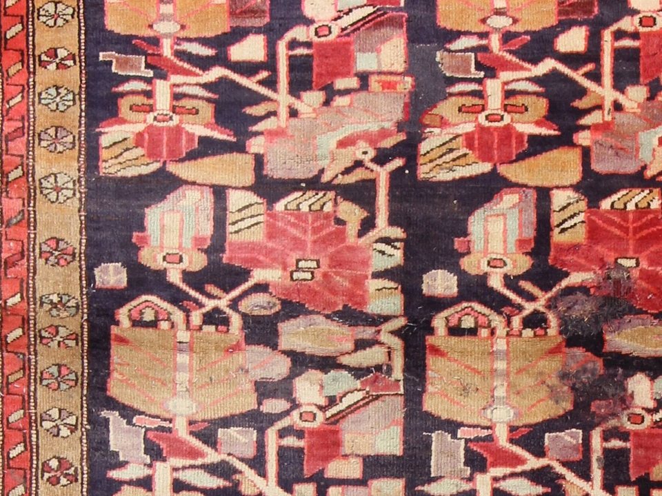 Kurdish tribal rug with abstract palmettes on a dark field